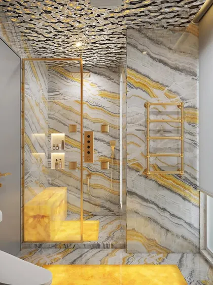 This bathroom design features a glowing honey onyx feature wall, illuminated with LED panels to create a warm, ambient glow. The gold fixtures and unique textured ceiling add to the luxurious feel.