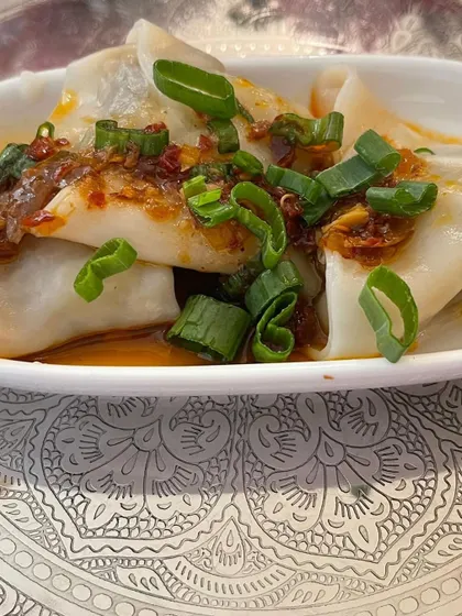 Our handmade chicken dim sum, plated as an appetizer for a sit-down meal. The presentation on an elegant silver-patterned plate adds a touch of sophistication.