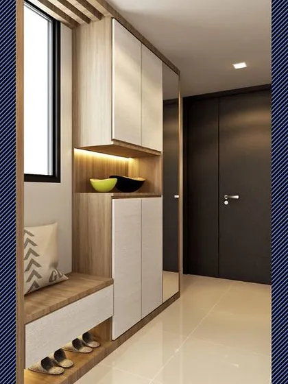 This foyer design maximizes storage with a full-height cabinet that includes a mirror, open shelving, and a seating bench with shoe storage underneath.