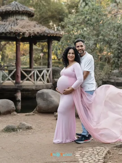 A classic pose with a beautiful backdrop. The gazebo and pond in this Mumbai park created a picturesque setting for this happy couple's maternity photo.