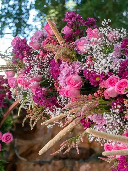 A lush arrangement of pink and purple flowers from our 'Pomegranate Spring' theme. The mix of roses, chrysanthemums, and baby's breath creates a rich texture and vibrant pop of color.