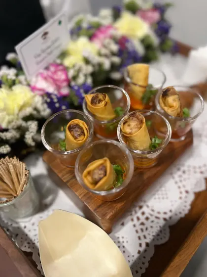 Our mini spring rolls are always a hit. Here they are served in shot glasses with sweet chili sauce, a creative and clean way for guests to enjoy this classic appetizer.