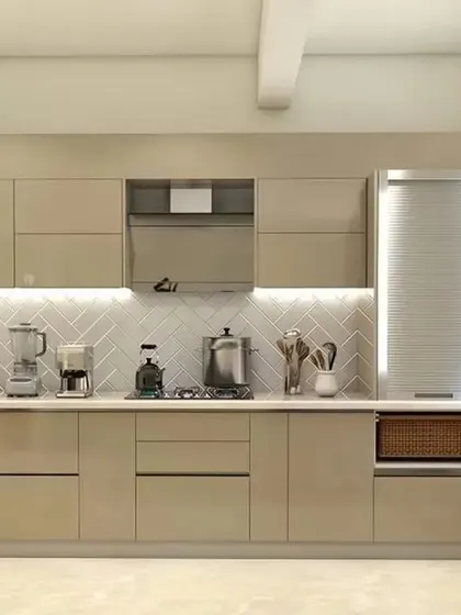 A minimalist straight-line kitchen in a calming beige tone. The handleless cabinets and integrated under-cabinet lighting create a seamless and sophisticated look.