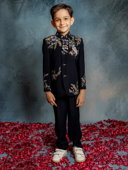 This is where modern style meets timeless craftsmanship. Our bestselling Indo-western jacket features intricate floral and bird embroidery on a classic black base, perfect for any celebration where your boy deserves to be the star.