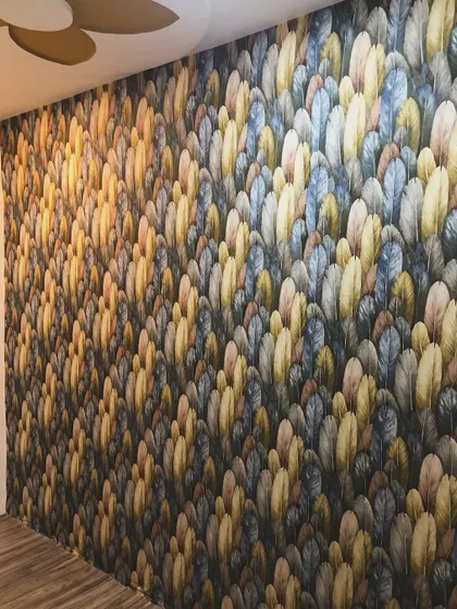 A full accent wall covered in a dense, colorful feather pattern. This bold design creates a rich, textured look that is very modern and stylish.
