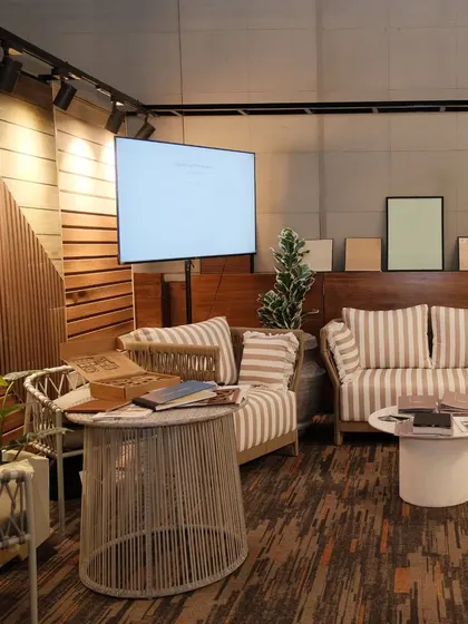 Our booth at the Casa Di Carnival in Bhubaneswar. This setup features a cozy lounge area with striped upholstery, set against a backdrop of our wooden wall panels.