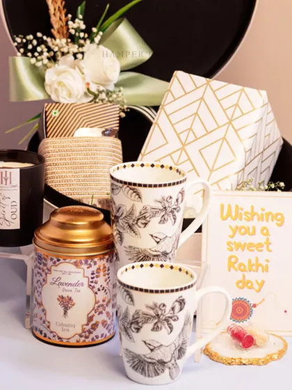 A peek inside the white leather Rakhi box, revealing a scented candle, lavender tea, and elegant matching mugs. It’s a perfect hamper for a relaxing and indulgent experience.