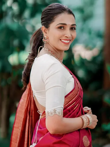 A simple yet elegant design can be incredibly versatile. I created this off-white blouse with delicate lace and hand embroidery on the sleeves, a timeless piece that can be paired with many different sarees.