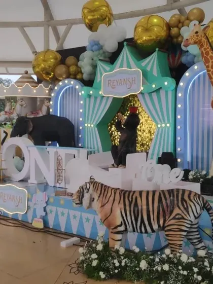 A pastel-colored circus stage with a full cast of animal props including a tiger, elephant, and giraffe, perfect for a first birthday.