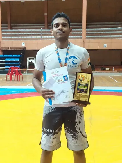 Holding my gold medal and certificate. The hard work in the gym always pays off on competition day.