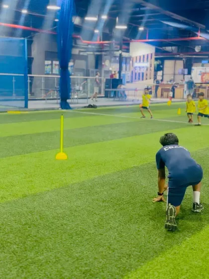 A coach demonstrates a bear crawl, a fun and effective exercise for building core strength and coordination.