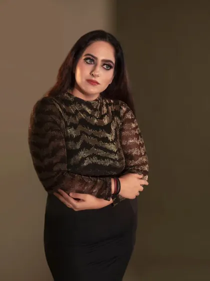 A simple yet powerful portrait. The focus here is on the model's expression and the dramatic, smokey eye makeup. The soft, diffused lighting creates a contemplative and soulful mood.