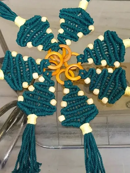 A different take on holiday decor, these are our macrame Christmas tree ornaments. Made with teal cord and wooden beads, they add a lovely rustic and bohemian vibe to your festive decorations.
