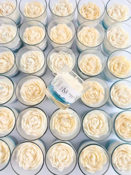 An overhead shot of the 'Save-the-Date' candles, highlighting the glitter-dusted white peony flower on top of the layered wax.