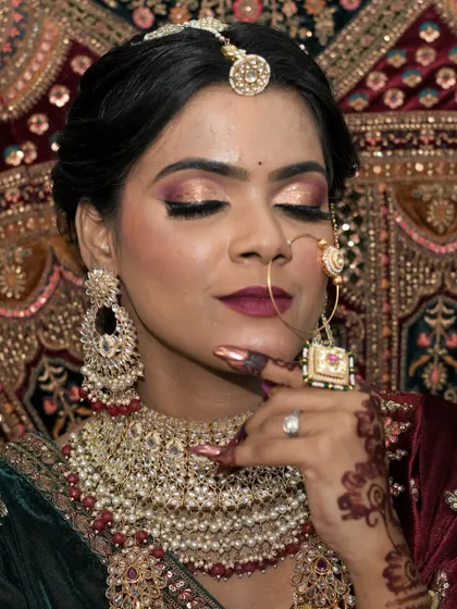 A beautiful portrait of a bride on her special day. Her makeup is a blend of traditional and modern styles, with flawless skin and eyes that sparkle.