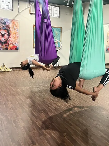 Mother and daughter practicing an aerial backbend together. This beautiful shot captures how fitness can be a shared, bonding experience at our studio.