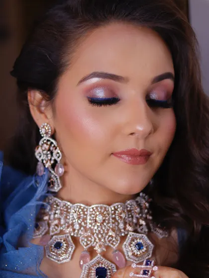 The details of this eye makeup are just mesmerizing. The blue liner on the lower lash line adds an unexpected pop of color that ties the whole look together.