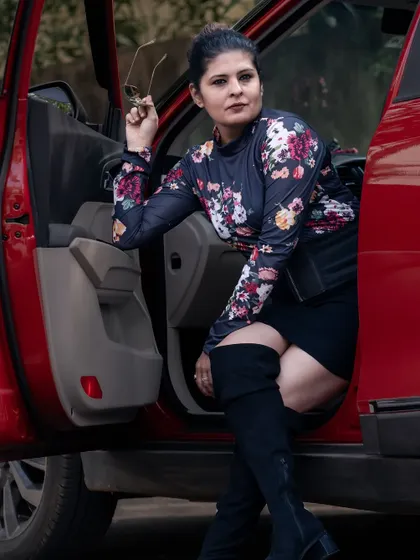 A bold fusion look with a floral high-neck top, a black mini-skirt, and thigh-high boots. This is for the woman who isn't afraid to be the center of attention.