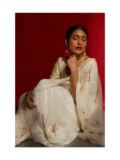 A serene and graceful shot from the same series. The closed eyes and soft lighting create a moment of quiet contemplation, adding an artistic touch to the lookbook.