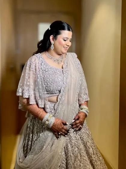 Delicate, dreamy, and divine. This bride looks absolutely angelic with her soft curls and a simple, elegant lehenga for her reception.