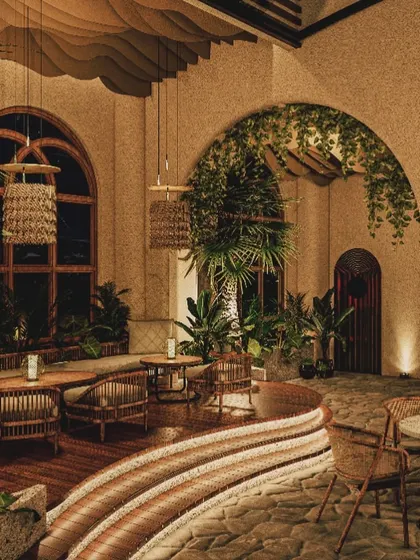 A render of the Nido restobar, visualizing the biophilic design with lush greenery, natural textures, and arched windows. This was our goal: to create a space that feels like an organic, immersive escape.