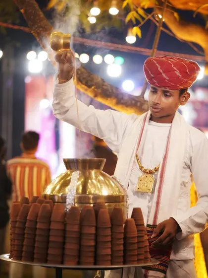 Another view of our traditional chaiwala in action, pouring tea with skill and flair. This adds a rustic and charming element to any celebration.