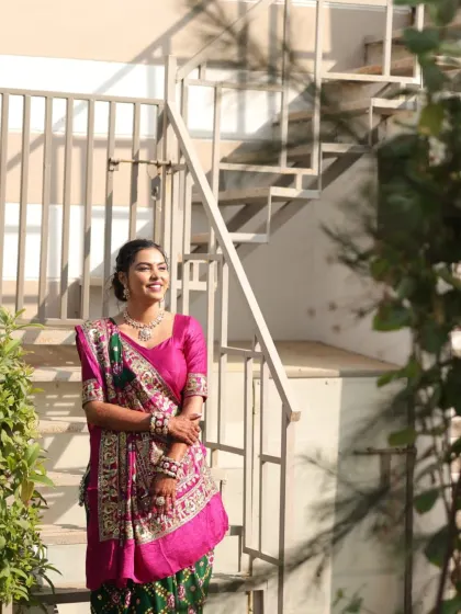 A full-length shot of the client, looking graceful in her traditional saree.
