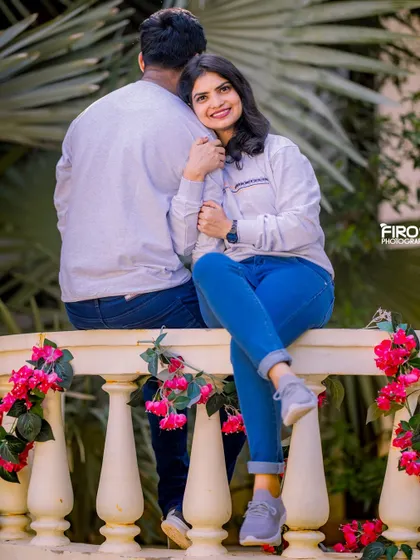 A sweet and candid moment on a white balustrade. The bride's happy smile as she looks back at the camera is what makes this shot so special.
