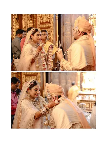 The exchange of varmala at a temple wedding, a sacred and intimate moment between the couple.
