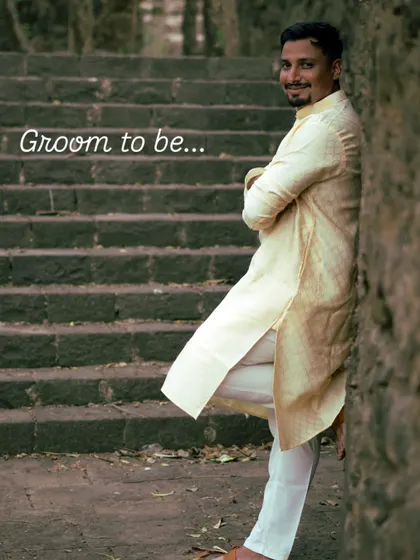 A confident portrait of the groom to be, leaning against ancient stone steps. This solo shot is an important part of the pre-wedding narrative, capturing his personality before the big day.