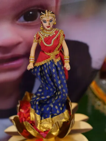 Another view of my half-saree doll, showcasing the intricate jewelry and the delicate fabric of her traditional dress.