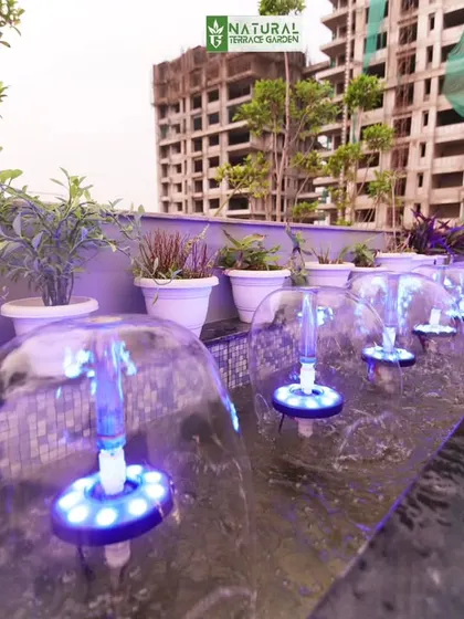 A close-up of the bubble jet fountain feature in our Sushant Lok project, with integrated blue LED lights that create a mesmerizing effect at night.