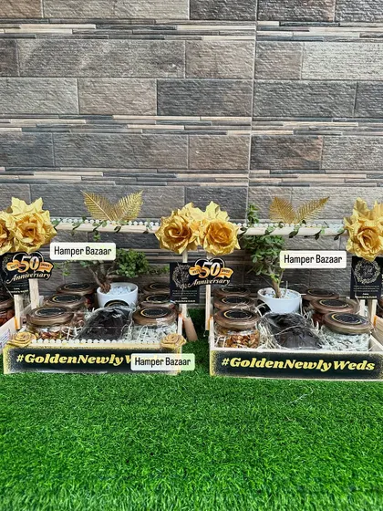 A full view of the Golden Jubilee anniversary hampers. Each one includes six jars of assorted snacks, a dry cake, and an indoor jade plant in a ceramic planter, making it a gift that lasts.