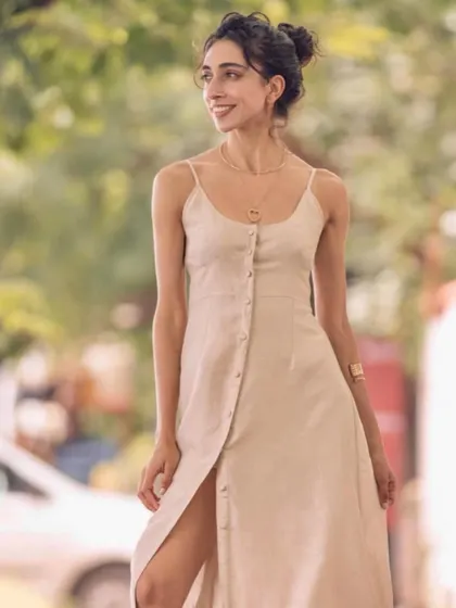 A candid moment during a photoshoot in a beautiful, neutral-toned dress. Hinting at new music to come.