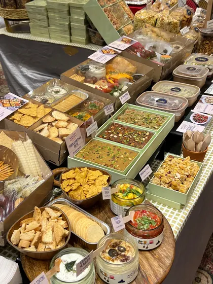 It was a joy to see my signature dips, salads, and desserts completely sell out at the Jalsa Exhibition. This is a snapshot of my stall, bustling with happy customers and showcasing the variety of ready-to-eat items I offer.