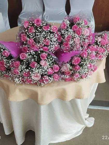 Bouquets of fresh pink roses and baby's breath prepared for a conference at The Acres Club. We provide all types of floral arrangements to suit the needs of corporate events.