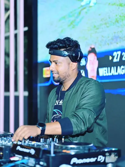 At the decks during a live cricket screening. I can seamlessly integrate my music into live sports events to keep the energy high during breaks.