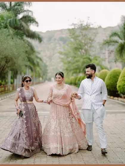 The bride walking with her siblings, a beautiful portrait capturing family bonds and coordinated outfits.