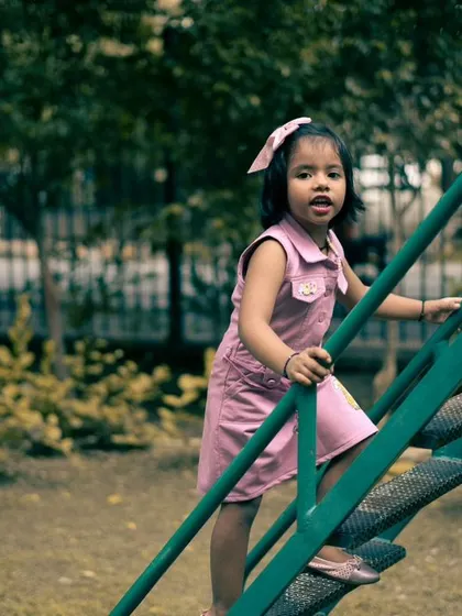 Capturing the little adventures, like climbing the steps of a slide. These action shots add a story-telling element to a family photo album.
