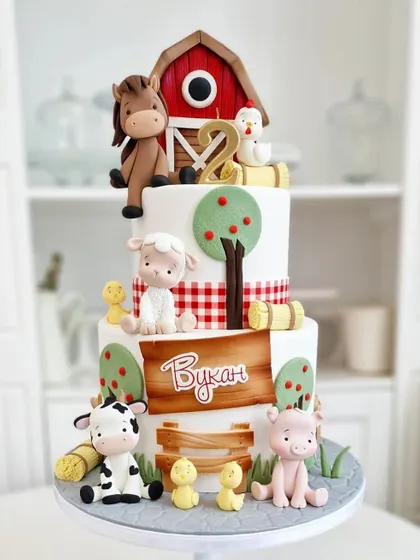 A three-tiered farm animal cake, complete with a barn, horse, cow, and pig. Learn to model a variety of animals and create a charming farm scene.