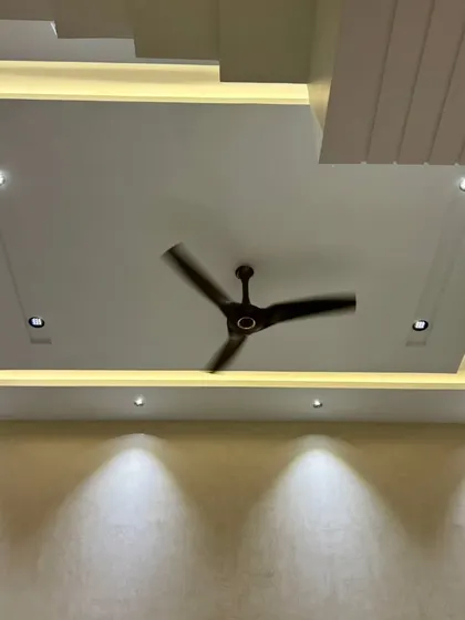 The false ceiling in this room is equipped with both cove lighting and spotlights, all automated to provide flexible lighting options, from ambient to task-focused.