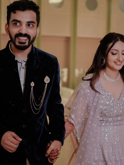 The couple's entrance at the Sangeet. The bride is glowing as she walks in, ready for a night of celebration.