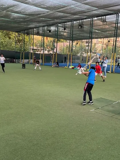 A young cricketer takes a mighty swing during a multisport birthday party. We set up the pitch for maximum fun and safety.
