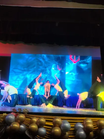 Another dynamic pose from the stage performance. Choreographing and executing such sequences builds immense confidence and a deep understanding of group dynamics.