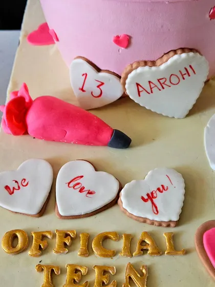 A close-up of the edible, hand-lettered cookies that spell out "We love you!" and mark the "Official Teen" 13th birthday.