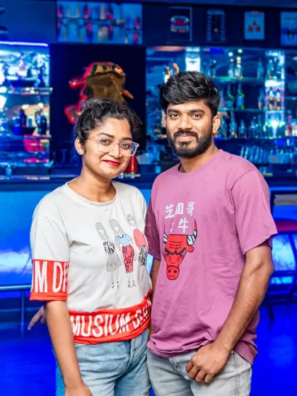 A couple posing for a picture. The casual and friendly vibe makes it a great spot for a relaxed night out.