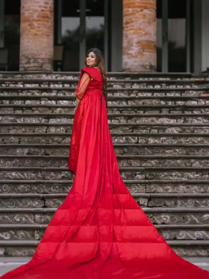 A full view of the magnificent quilted trail on this red gown. The detachable sleeves have been removed here, showcasing a different style for this versatile rental piece.