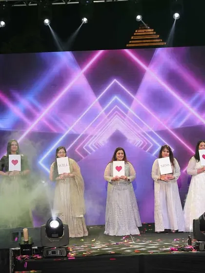 A creative performance by the bridesmaids using placards to share messages of love for the bride.