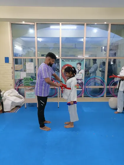 Tying a red belt.