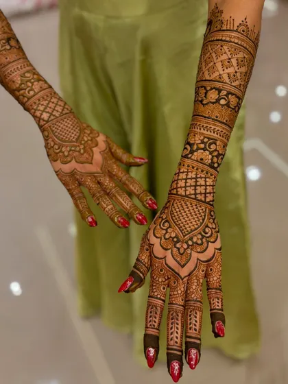 An angled view of the wedding mehendi against a soft green background.